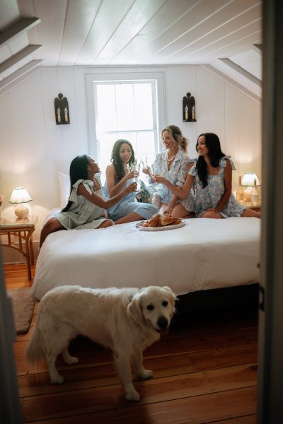 Bridesmaids and bride cheers inside The Cottage at Wicklow Hall